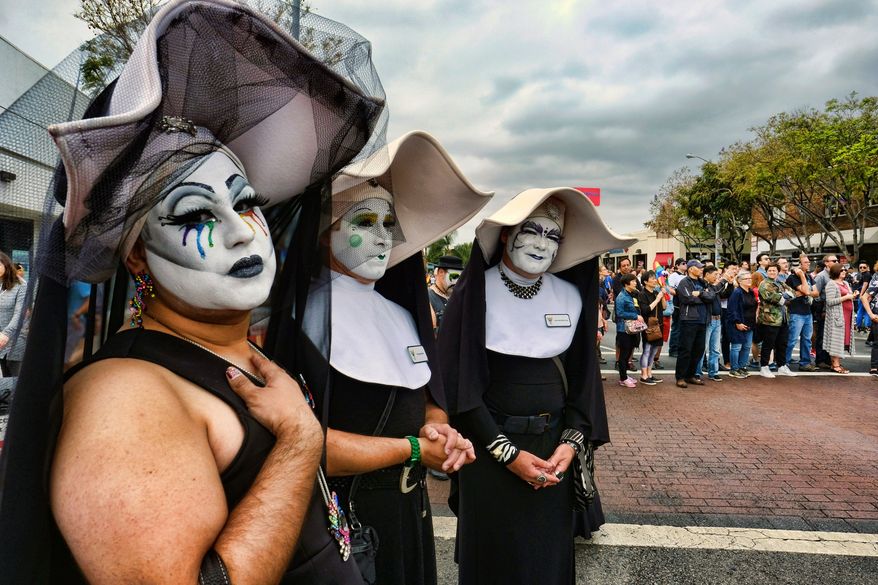 FILE - The Sisters of Perpetual Indulgence show their support during the gay pride parade in West Hollywood, Calif., on Sunday, June 12, 2016. The Los Angeles Dodgers have reinvented a satirical LGBTQ+ group called the Sisters of Perpetual Indulgence to receive an award at the team's annual Pride Night, nearly a week after rescinding the original invitation. The Dodgers said Monday, May 22, 2023, that the charity and performance group will receive the Community Hero Award on June 16. (AP Photo/Richard Vogel,File)