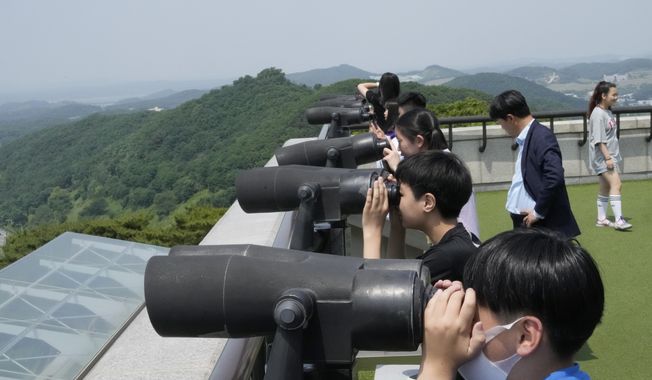 Elementary school students watch the North Korea side from the Unification Observation Post in Paju, South Korea, near the border with North Korea, Wednesday, May 31, 2023. North Korea&#x27;s attempt to put the country&#x27;s first spy satellite into space failed Wednesday in a setback to leader Kim Jong-un&#x27;s push to boost his military capabilities as tensions with the United States and South Korea rise. (AP Photo/Ahn Young-joon)