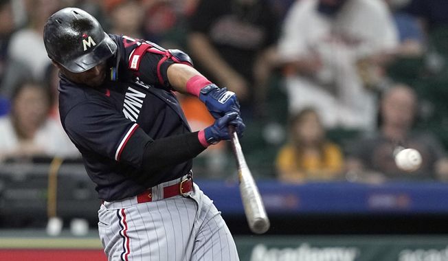 Minnesota Twins&#x27; Donovan Solano hits a two-run single against the Houston Astros during the third inning of a baseball game Wednesday, May 31, 2023, in Houston. (AP Photo/David J. Phillip)