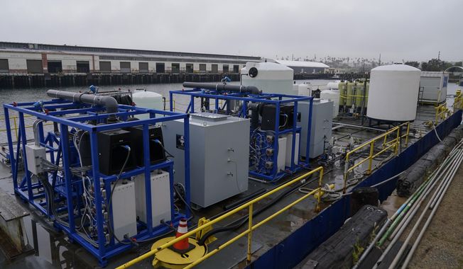 A demonstration site of a seawater-based carbon removal system is set up on a barge, Wednesday, April 12, 2023, in San Pedro, Calif. Equatic, a Los Angeles startup that is designing facilities to remove carbon dioxide from the ocean says it has struck an agreement with Boeing to provide the aerospace giant with a byproduct of the process to help it cut emissions from planes. (AP Photo/Ashley Landis, File)