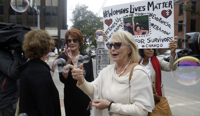 Victoria Valentino, center, appears with a protester near the Montgomery County Courthouse on Sept. 24, 2018, in Norristown, Pa. A former Playboy model who alleges Bill Cosby drugged and raped her and another woman at his home in 1969 sued the entertainer Thursday, June 1, 2023, in Los Angeles under a new California law that suspends the statute of limitations on sex abuse claims. In her lawsuit, Victoria Valentino, 80, says she was an actress and singer 54 years ago when she met Cosby. (AP Photo/Jacqueline Larma, File)