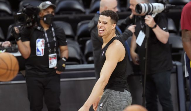 Denver Nuggets forward Michael Porter Jr. jokes with teammates during practice ahead of Game 1 of the NBA basketball finals against the Miami Heat Wednesday, May 31, 2023, in Denver. (AP Photo/David Zalubowski)