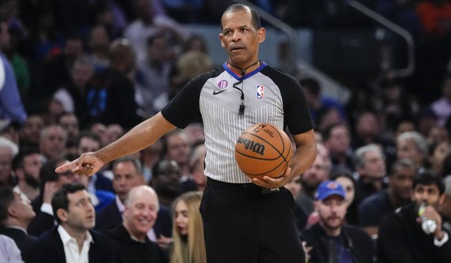 Referee Eric Lewis gestures during the first half of Game 5 of the NBA basketball Eastern Conference semifinal between the New York Knicks and the Miami Heat on May 10, 2023, in New York. Lewis was not selected as one of the 12 referees who will work the NBA Finals between the Denver Nuggets and Miami Heat, while the league continues to look into whether he used a Twitter account to defend himself and other officials from online critiques. Lewis had been chosen to work the finals in each of the last four seasons. (AP Photo/Frank Franklin II, File)