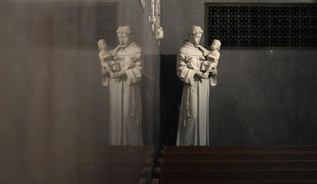 A statue of St. Anthony holding the infant Jesus is reflected in a wall in St. Aloysius Catholic Church, Friday, May 26, 2023, in Detroit. In the year since the Supreme Court struck down the nationwide right to abortion, America&#x27;s religious leaders and denominations have responded in strikingly diverse ways. The divisions are epitomized in the country&#x27;s largest denomination – the Catholic Church. National polls repeatedly show that a majority of U.S. Catholics believe abortion should be legal in all or most case, yet the U.S. Conference of Catholic Bishops supports sweeping bans on the procedure. (AP Photo/Carlos Osorio)