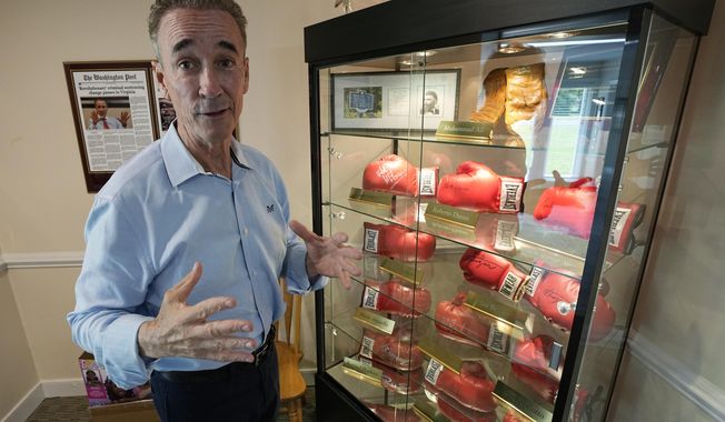 Virginia state Sen. Joe Morrissey gestures in front of his collection of autographed boxing gloves during an interview in his office Monday, May 22, 2023, in Richmond, Va. Morrissey is being challenged in a Democratic primary for a newly-redrawn senatorial district by former Delegate Lashrecse Aird. (AP Photo/Steve Helber)