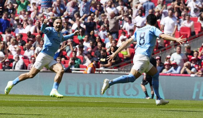 Manchester City&#x27;s Ilkay Gundogan celebrates after scoring his side&#x27;s first goal during the English FA Cup final soccer match between Manchester City and Manchester United at Wembley Stadium in London, Saturday, June 3, 2023.(AP Photo/Jon Super)
