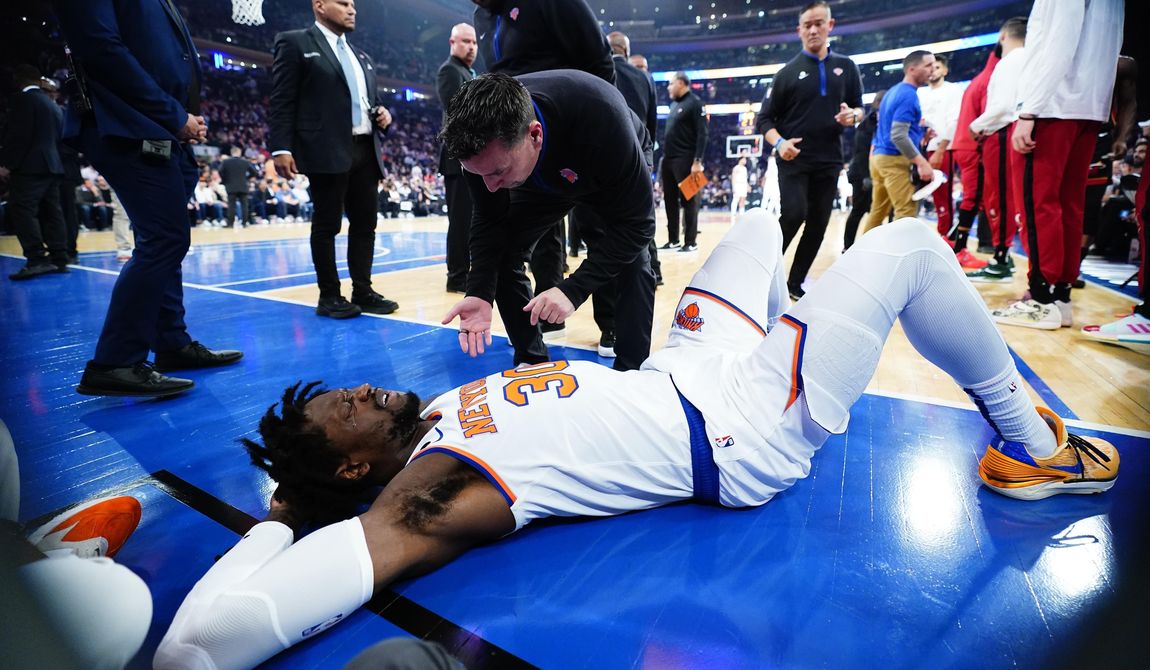 A trainer checks on New York Knicks&#x27; Julius Randle (30) after he was hurt during the first half of Game 5 of the team&#x27;s NBA basketball Eastern Conference playoff semifinal against the Miami Heat on Wednesday, May 10, 2023, in New York. The Knicks won 112-103. (AP Photo/Frank Franklin II)