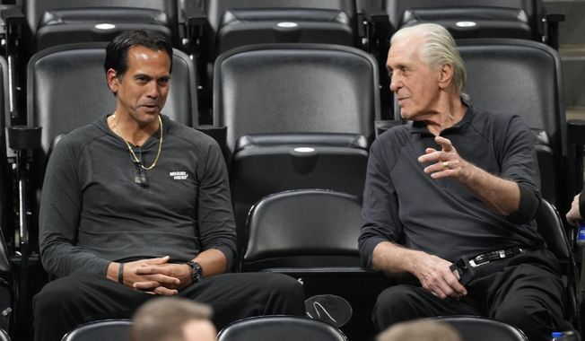 Miami Heat head coach Erik Spoelstra, left, chats with team president Pat Riley as they watch players practice for Game 2 of the NBA Finals, Saturday, June 3, 2023, in Denver. (AP Photo/David Zalubowski