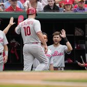 Philadelphia Phillies&#x27; J.T. Realmuto (10) high-fives teammates after scoring on Josh Harrison&#x27;s single in the second inning of a baseball game against the Washington Nationals, Saturday, June 3, 2023, in Washington. (AP Photo/Patrick Semansky)