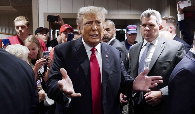 Former President Donald Trump greets supporters before speaking at the Westside Conservative Breakfast, June 1, 2023, in Des Moines, Iowa. As Ron DeSantis embarked on the first official week of his presidential candidacy, the Florida governor repeatedly hit his chief rival, Trump, from the right. (AP Photo/Charlie Neibergall, File)