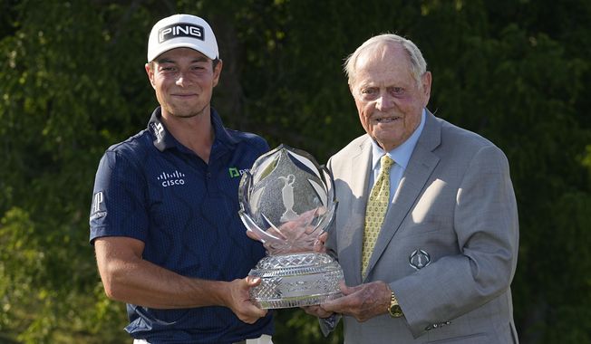 Viktor Hovland, left, of Norway, and Jack Nicklaus hold the trophy after Hovland won the Memorial golf tournament, Sunday, June 4, 2023, in Dublin, Ohio. (AP Photo/Darron Cummings)