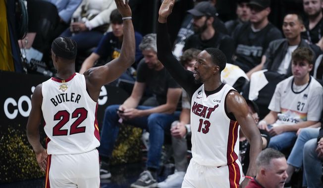 Miami Heat center Bam Adebayo, right, celebrates with forward Jimmy Butler after scoring against the Denver Nuggets during the second half of Game 2 of basketball&#x27;s NBA Finals, Sunday, June 4, 2023, in Denver. (AP Photo/David Zalubowski)