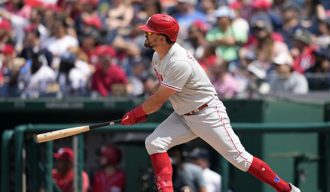 Philadelphia Phillies&#x27; Kyle Schwarber watches his three-run home run in the sixth inning of a baseball game against the Washington Nationals, Sunday, June 4, 2023, in Washington. (AP Photo/Patrick Semansky)