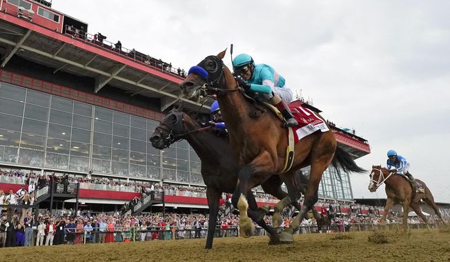 National Treasure, with jockey John Velazquez, edges out Blazing Sevens, with jockey Irad Ortiz Jr., to win the148th running of the Preakness Stakes horse race at Pimlico Race Course, Saturday, May 20, 2023, in Baltimore. Kentucky Derby winner Mage, right, finished third. (AP Photo/Julio Cortez)