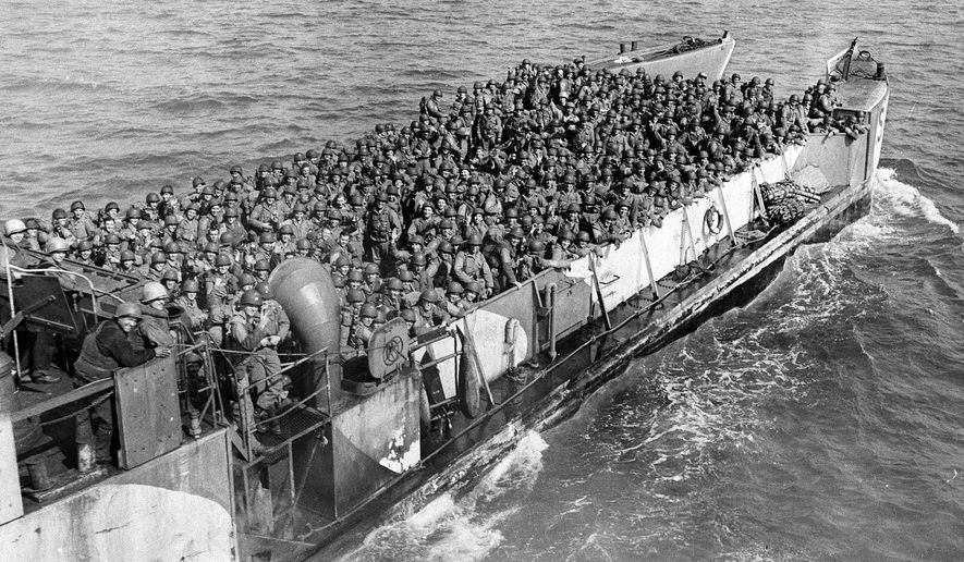 FILE - American troops pack a landing craft underway to a beachhead at the northern coast of France, during the Allied invasion of Normandy, June 19, 1944. The D-Day invasion that helped change the course of World War II was unprecedented in scale and audacity. Veterans and world dignitaries are commemorating the 79th anniversary of the operation. (AP Photo, File)