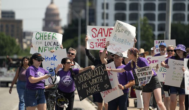 Editorial members of the Austin American-Statesman&#x27;s Austin NewsGuild picket along the Congress Avenue bridge in Austin, Texas, Monday, June 5, 2023. The mostly one-day strike aims to protest the company&#x27;s leadership and cost-cutting measures imposed since its 2019 merger with GateHouse Media. (AP Photo/Eric Gay)