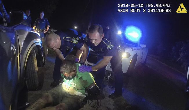 This file image from Louisiana State Police Trooper Dakota DeMoss&#x27; body-worn camera video shows other troopers holding up Ronald Greene before paramedics arrived on May 10, 2019, outside of Monroe, La. The video obtained by The Associated Press shows Louisiana state troopers stunning, punching and dragging the Black man as he apologizes for leading them on a high-speed chase. Greene died in police custody. (Louisiana State Police via AP, File)