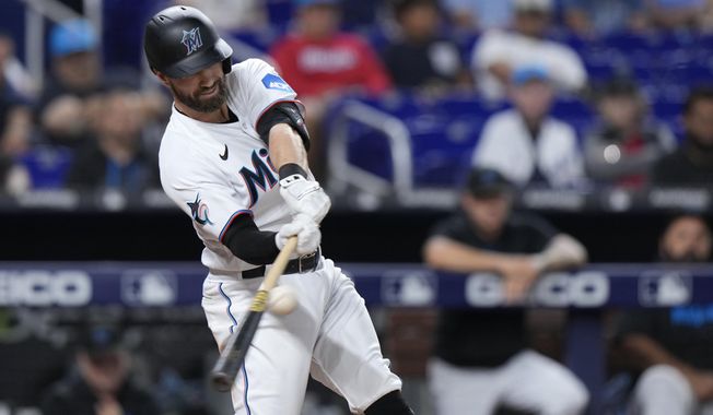 Miami Marlins&#x27; Jon Berti hits a triple scoring Nick Fortes and Joey Wendle during the fourth inning of a baseball game against the Kansas City Royals, Monday, June 5, 2023, in Miami. (AP Photo/Wilfredo Lee)
