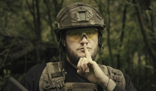 In this image made from video provided by Ukrainian Defense Ministry on Sunday, June 4, 2023, a Ukrainian soldier poses for the camera with his fingers to his lips, in an undisclosed location in Ukraine. A video released by the Ukrainian Defense Ministry on Sunday shows its military gesturing to silence suggesting that no formal announcement of a possible counter offensive against Russia will be made. The on-screen text of the video reads &quot;Plans love silence. There will be no announcement of the start.&quot; (Ukrainian Defense Ministry via AP)