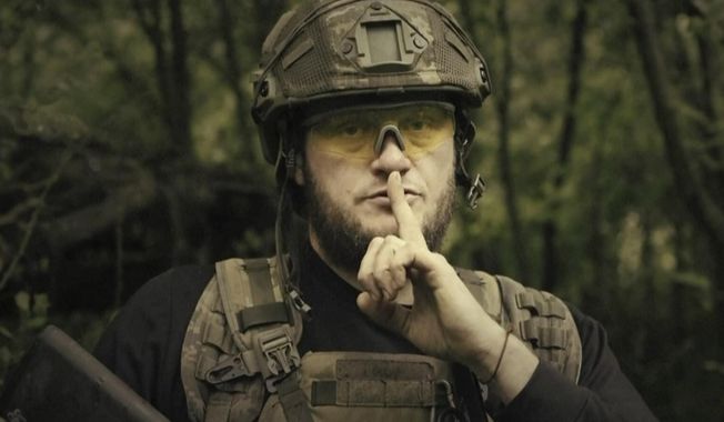 In this image made from video provided by Ukrainian Defense Ministry on Sunday, June 4, 2023, a Ukrainian soldier poses for the camera with his fingers to his lips, in an undisclosed location in Ukraine. A video released by the Ukrainian Defense Ministry on Sunday shows its military gesturing to silence suggesting that no formal announcement of a possible counter offensive against Russia will be made. The on-screen text of the video reads &quot;Plans love silence. There will be no announcement of the start.&quot; (Ukrainian Defense Ministry via AP)