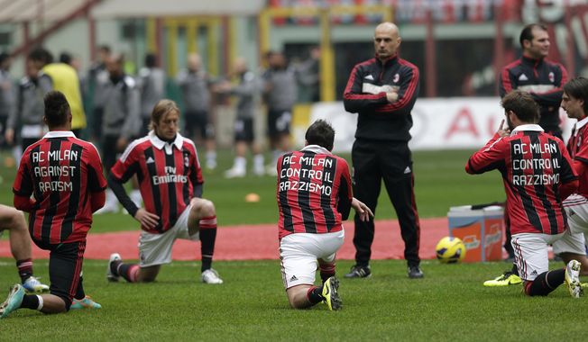 From left, AC Milan&#x27;s Kevin-Prince Boateng, Massimo Ambrosini, Giampaolo Pazzini and Antonio Nocerino sport jerseys reading &quot;AC Milan against racism&quot; as they warm up prior to the start of the Serie A soccer match between AC Milan and Siena at the San Siro stadium in Milan, Italy, Sunday, Jan. 6, 2013. The manifestation of a deeper societal problem, racism is a decades-old issue in soccer — predominantly in Europe but seen all around the world — that has been amplified by the reach of social media and a growing willingness for people to call it out. (AP Photo/Antonio Calanni, File)