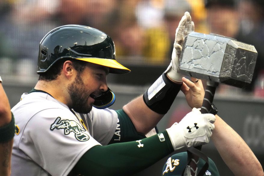 Oakland Athletics' Shea Langeliers, left, celebrates as he returns to the dugout after hitting a solo home run off Pittsburgh Pirates starting pitcher Mitch Keller during the second inning of a baseball game in Pittsburgh, Tuesday, June 6, 2023. (AP Photo/Gene J. Puskar)