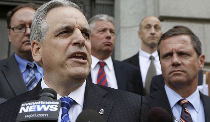 U.S. Attorney Peter Neronha, front left, responds to questions from reporters outside federal court, June 11, 2015, in Providence, R.I. A major Rhode Island landlord whose tenants have long complained about lead hazards, rodent infestations and other problems was sued Tuesday, June 6, 2023 by the state attorney general, Peter Neronha, who said conditions at many of the properties put renters' health and safety at risk. (AP Photo/Steven Senne) **FILE**