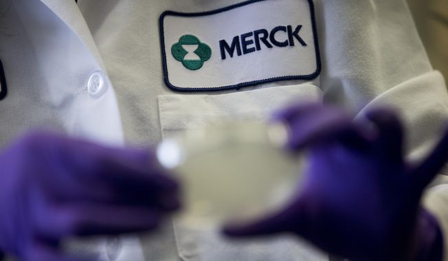 A Merck scientist conducts research on Feb. 28, 2013, in West Point, Pa. Merck is suing the federal government Tuesday, June 6, 2023, over a plan to negotiate Medicare drug prices, calling the program a sham equivalent to extortion. The drugmaker is seeking to halt the program, which was laid out in the Inflation Reduction Act and is expected to save taxpayers billions of dollars in the coming years. (AP Photo/Matt Rourke) **FILE**