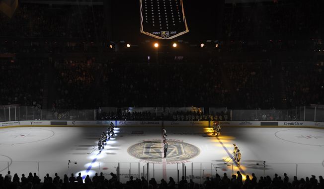 A moment of silence is held inside T-Mobile Arena honoring the fourth anniversary of the Las Vegas shooting before an NHL preseason hockey game between the Vegas Golden Knights and the Los Angeles Kings Friday, Oct. 1, 2021, in Las Vegas. The Vegas Golden Knights and Florida Panthers were connected by tragedy five years before meeting in the Stanley Cup Final. (AP Photo/David Becker, File)