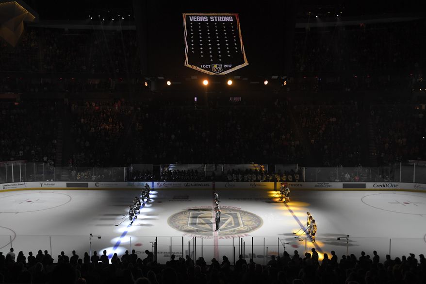 A moment of silence is held inside T-Mobile Arena honoring the fourth anniversary of the Las Vegas shooting before an NHL preseason hockey game between the Vegas Golden Knights and the Los Angeles Kings Friday, Oct. 1, 2021, in Las Vegas. The Vegas Golden Knights and Florida Panthers were connected by tragedy five years before meeting in the Stanley Cup Final. (AP Photo/David Becker, File)