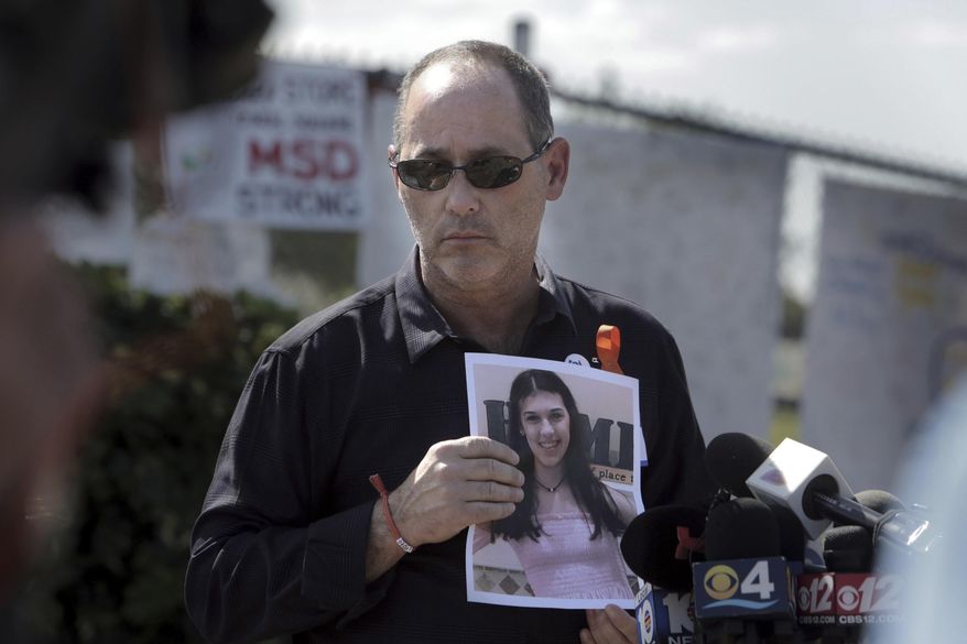 FILE - Fred Guttenberg, father of Jaime Guttenberg, holds a picture of his daughter, Monday, March 5, 2018, as he listens to questions from the media in front of Marjory Stoneman Douglas High School, in Parkland, Fla. “The idea that these two teams, impacted by gun violence at almost the same time, are now playing each other for the Stanley Cup is such a huge deal,” said Fred Guttenberg, whose 14-year-old daughter Jaime died at Stoneman Douglas. (Jose A. Iglesias/Miami Herald via AP, File)