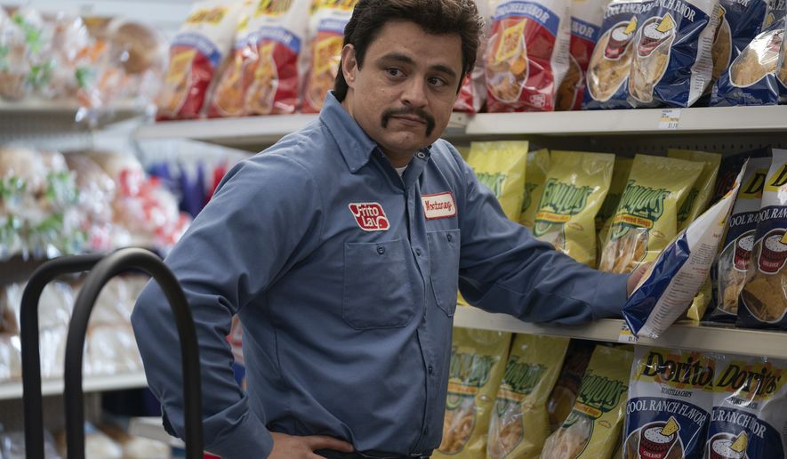 This image released by Searchlight Pictures shows Jesse Garcia in a scene from "Flamin' Hot," a tale of how a Mexican American janitor came up with the idea for Flamin’ Hot Cheetos. (Emily Aragones/Searchlight Pictures via AP)