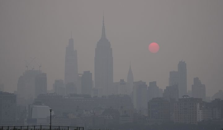 The sun rises over a hazy New York City skyline as seen from Jersey City, N.J., Wednesday, June 7, 2023. Intense Canadian wildfires are blanketing the northeastern U.S. in a dystopian haze, turning the air acrid, the sky yellowish gray and prompting warnings for vulnerable populations to stay inside. (AP Photo/Seth Wenig)