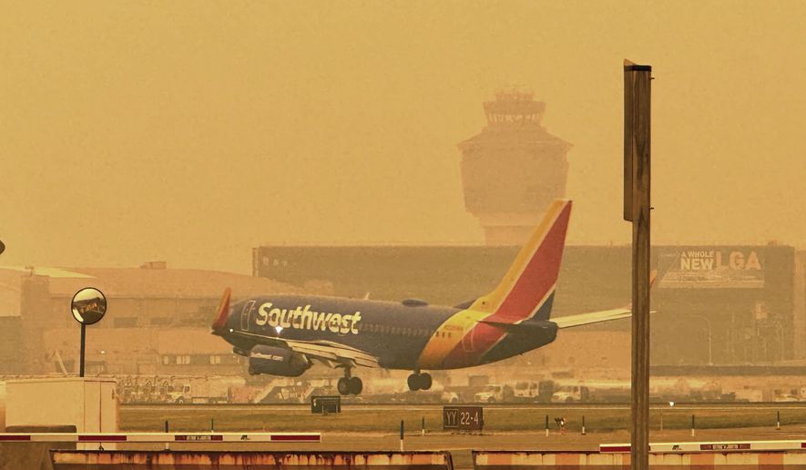 A Southwest airliner approaches LaGuardia Airport in New York, Wednesday, June 7, 2023. The Federal Aviation Administration paused some flights bound for LaGuardia Airport and slowed planes to Newark Liberty and Philadelphia because the smoke from wildfires in Canada was limiting visibility. It also contributed to delayed arrivals at Dulles International Airport outside Washington. (AP Photo/David R. Martin)