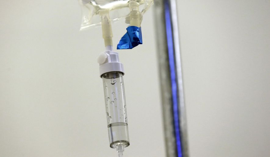 In this May 25, 2017 file photo, chemotherapy drugs are administered to a patient at a hospital in Chapel Hill, N.C. A growing shortage of common cancer treatments is forcing doctors to switch medications and delaying care, prominent U.S. cancer centers say. The National Comprehensive Cancer Network said Wednesday, June 7, 2023, that nearly all the centers it surveyed in late May 2023 were dealing with shortages of the chemotherapies carboplatin and cisplatin. (AP Photo/Gerry Broome)