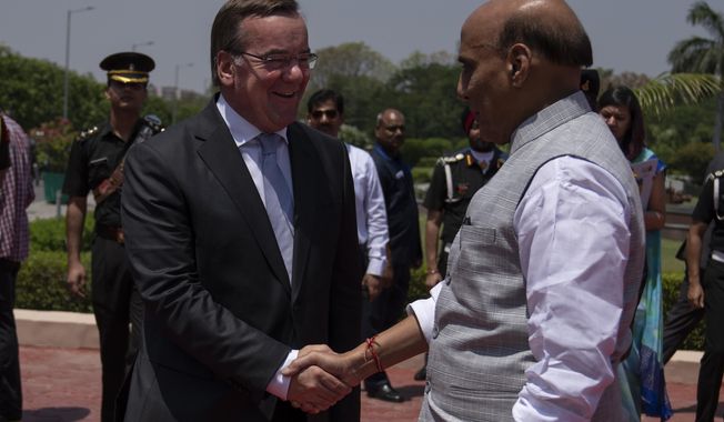 Indian Defense Minister Rajnath Singh welcomes German Defense Minister Boris Pistorius in New Delhi, India, Tuesday, June 6, 2023. (AP Photo/Altaf Qadri)
