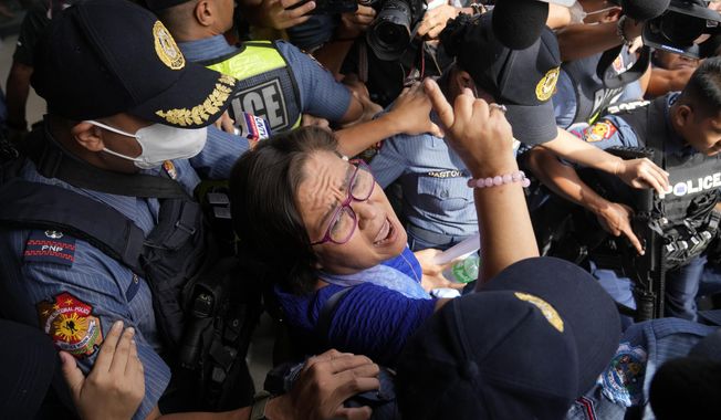 Detained ex-senator Leila de Lima reacts as she goes out of the Muntinlupa trial court to attend her trial on May 12, 2023 in Muntinlupa, Philippines. A Philippine court rejected on Wednesday June 7, 2023 a bail petition by a former Filipino senator and top human rights enforcer, who opposed then President Rodrigo Duterte&#x27;s deadly anti-drugs crackdown but was instead accused by his administration of drug dealing and locked up in jail more than six years ago. (AP Photo/Aaron Favila, File)