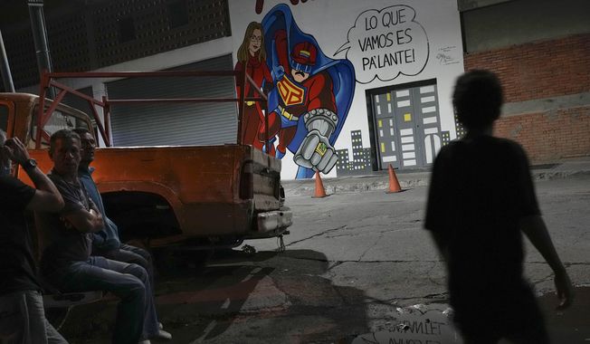 People stand near a mural of a cartoon character known as &quot;Super Bigote&quot;, or &quot;Super Moustache&quot;, that casts Venezuela&#x27;s President Nicolas Maduro as a super hero in Caracas, Venezuela, March 3, 2023. The United Socialist Party of Venezuela has controlled the nation and its oil wealth for a quarter-century, 15 years under Hugo Chávez and a decade under Maduro. (AP Photo/Matias Delacroix, File)