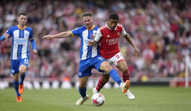 Brighton&#x27;s Alexis Mac Allister, left, challenges for the ball with Arsenal&#x27;s Reiss Nelson during the English Premier League soccer match between Arsenal and Brighton and Hove Albion at Emirates stadium in London, Sunday, May 14, 2023. (AP Photo/Kirsty Wigglesworth)