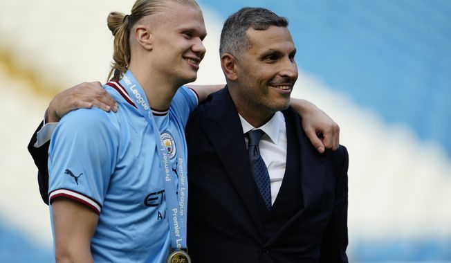 Chairman of Manchester City Khaldoon Al Mubarak, right, poses with Manchester City&#x27;s Erling Haaland after the English Premier League soccer match between Manchester City and Chelsea at the Etihad Stadium in Manchester, England, Sunday, May 21, 2023. (AP Photo/Jon Super)
