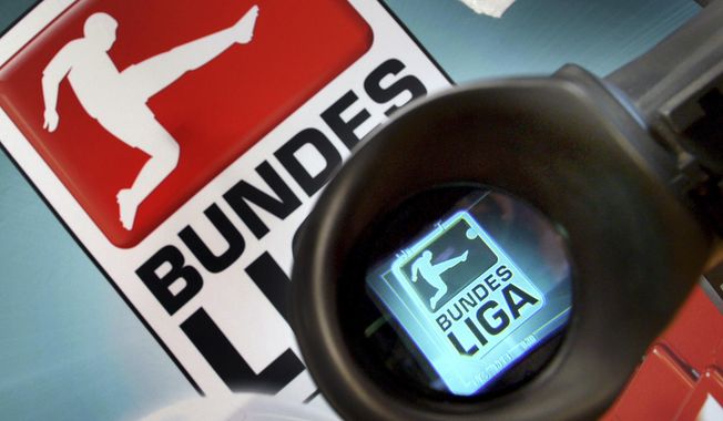 The logo of German Football League Bundesliga is seen through a camera prior to a press conference in Frankfurt, Germany, Oct. 9, 2007. The German soccer league (DFL) is appointing two more men to take over as chief executive officers from two men who took over from a woman last year. (AP Photo/Michael Probst, File)
