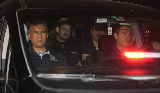Dutch citizen Joran van der Sloot, back left, is driven in a police vehicle from the Ancon I maximum-security prison, outskirts of Lima, Peru, Thursday, June 8, 2023. The main suspect in the unsolved 2005 disappearance of American student Natalee Holloway on the Caribbean island of Aruba is expected to be extradited Thursday from Peru to the United States. .(AP Photo/Martin Mejia)