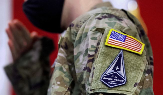 A soldier wears a U.S. Space Force uniform during a ceremony for U.S. Air Force airmen transitioning to U.S. Space Force guardian designations at Travis Air Force Base, Calif., Feb. 12, 2021. Ohio&#x27;s rich history of aviation innovation makes it an “ideally suited” location for the Air Force&#x27;s new U.S. Space Command headquarters or Space Force units, a group of the state&#x27;s congressional delegates told Democratic President Joe Biden in a letter Wednesday, June 7, 2023. (AP Photo/Noah Berger, File)
