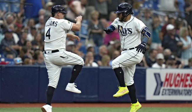 Tampa Bay Rays&#x27; Harold Ramirez, celebrates his two-run home run with third base coach Brady Williams (4) off Minnesota Twins starting pitcher Bailey Ober during the fourth inning of a baseball game Thursday, June 8, 2023, in St. Petersburg, Fla. (AP Photo/Chris O&#x27;Meara)
