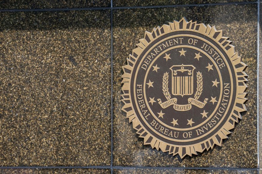 The seal on the J. Edgar Hoover FBI Building is seen Friday, June 9, 2023, in Washington. Former President Donald Trump has been indicted on charges of mishandling classified documents at his Florida estate. The remarkable development makes him the first former president in U.S. history to face criminal charges by the federal government that he once oversaw. (AP Photo/Alex Brandon)
