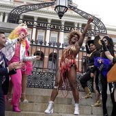 Drag performer Neon Calypso, center, sings and dances to Tina Turner&#x27;s version of the song &quot;Proud Mary,&quot; during a Pride Month Celebration, Wednesday, June 7, 2023, in front of the Statehouse, in Boston. The event included a performance of about a dozen drag performers at a time when some states have tried to target drag performances. (AP Photo/Steven Senne)