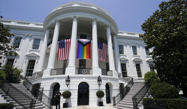 American flags and a pride flag hang from the White House during a Pride Month celebration on the South Lawn, Saturday, June 10, 2023, in Washington. (AP Photo/Manuel Balce Ceneta)