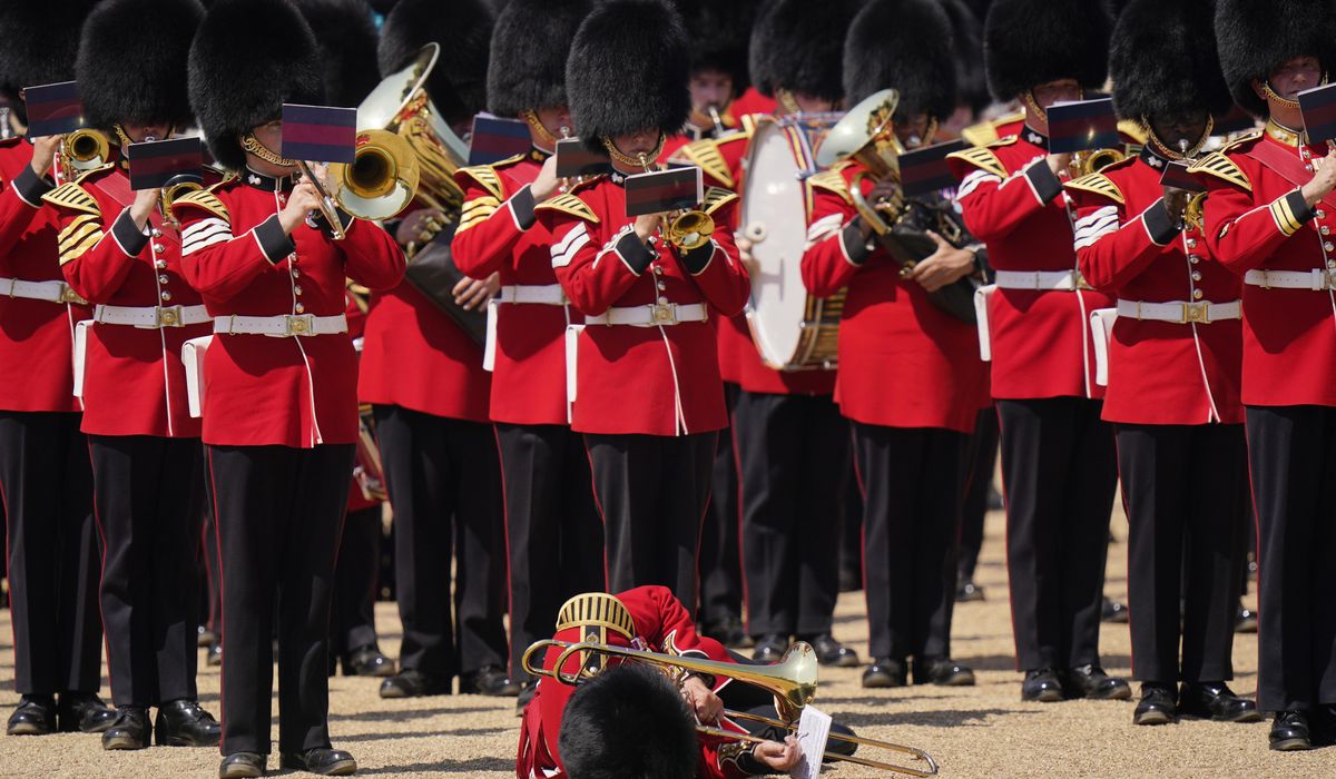 NextImg:Troops feel the heat, and several faint, as Prince William reviews military parade