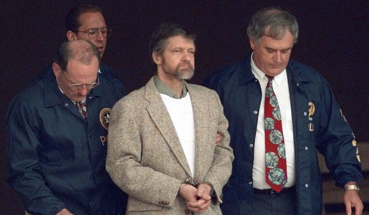 Theodore Kaczynski looks around as U.S. Marshals prepare to take him down the steps at the federal courthouse to a waiting vehicle on June 21, 1996, in Helena, Mont. A spokesperson for the Bureau of Prisons told The Associated Press that Kaczynski, known as the “Unabomber,” has died in federal prison. The cause of death was not immediately known. (AP Photo/Elaine Thompson, File)