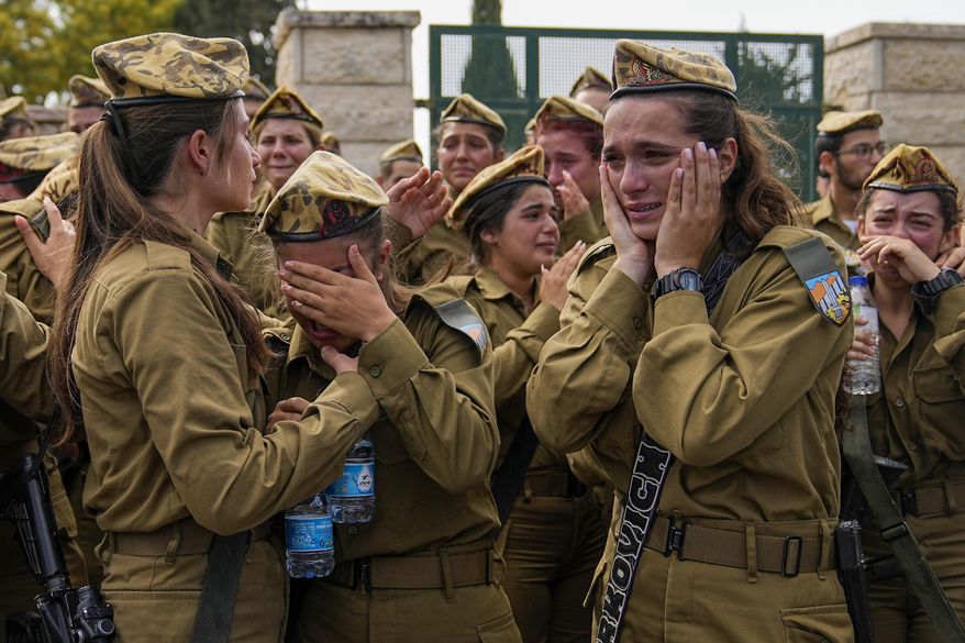 Israeli soldiers mourn during the funeral of Sgt. Lia Ben Nun, 19, in Rishon Lezion, Israel, Sunday, June 4, 2023. The Israeli army says Ben Nun was among three soldiers who were killed by an Egyptian border guard who crossed into Israel on Saturday before he was fatally shot by troops. (AP Photo/Ohad Zwigenberg)